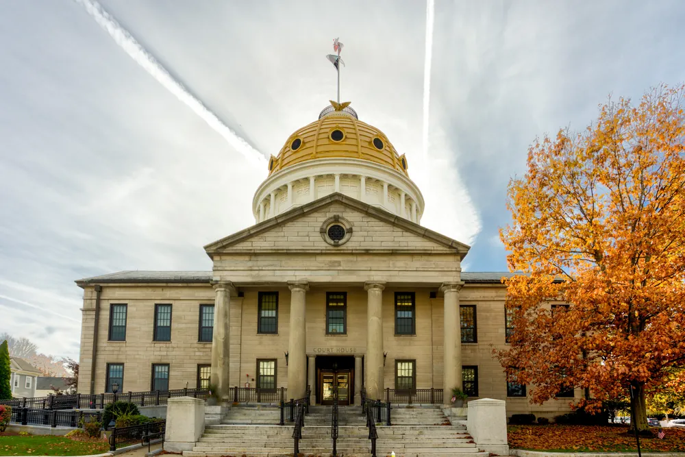 The domed Norfolk County Courthouse in Dedham, with granite columns and an orange autumn tree