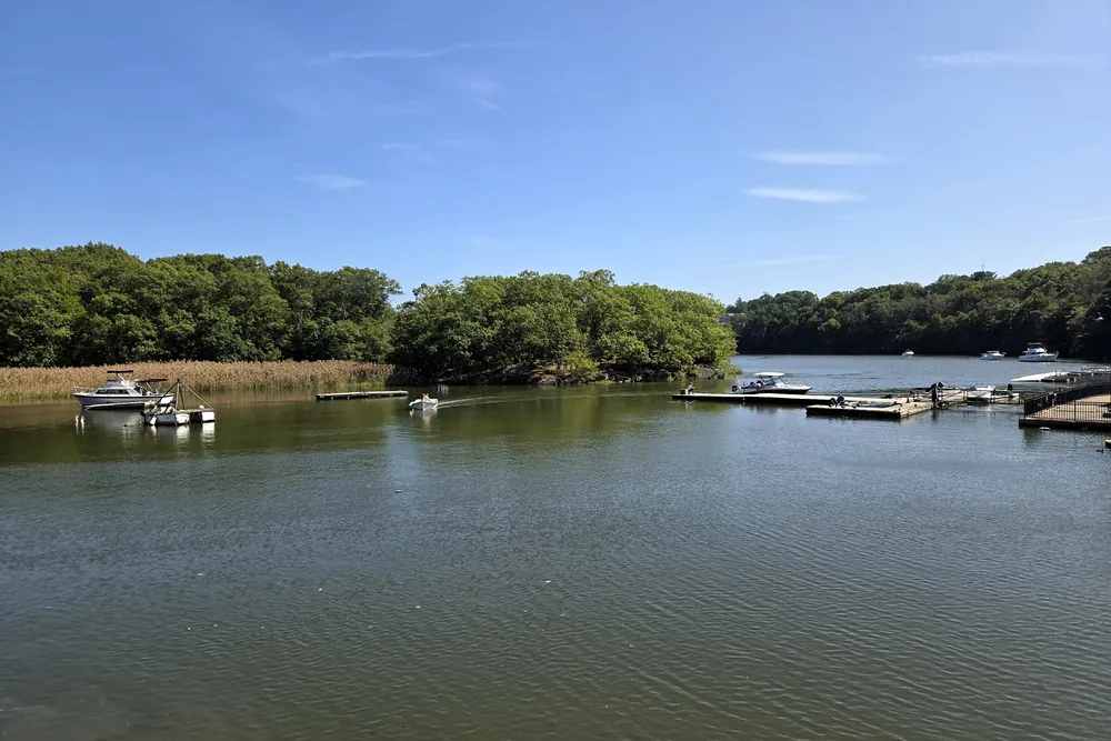 The Neponset River at Milton Lower Mills, with small boats at a dock and tree-lined banks